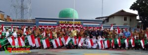 Pj Bupati Agara Pimpin Apel Gerakan Nasional Pembagian Bendera Merah Putih